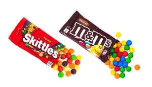 Skittles and M&Ms (by Mars) fruit dragee on white