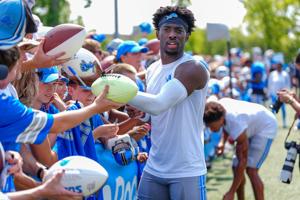 Detroit Lions CB Terrion Arnold signs autographs at the end of the joint practice with the Miami Dolphins at the Lions