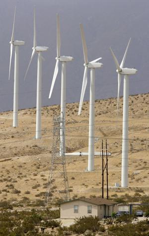 New larger windmills overlook a home near the intersection of Dillon Road and Highway 62 on July 26, 2006. More windmills may be