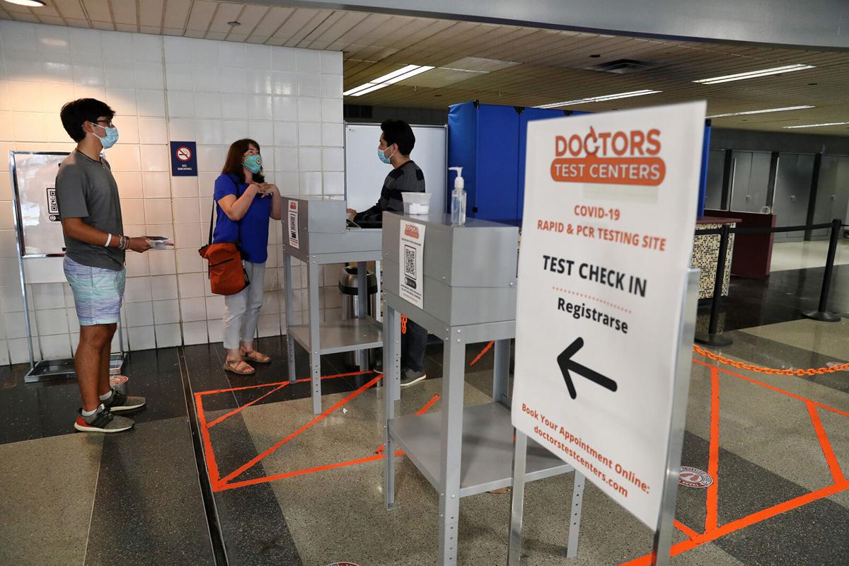 Anne-Laure Mostacero and her son, Timothee, 19, are checked in for their Covid-19 tests at Doctors Test Centers at Chicago's O'Hare International Airport on Thursday, May 20, 2021. The family was getting tested a day prior to their flight to Spain. They are moving from Deerfield to Barcelona.