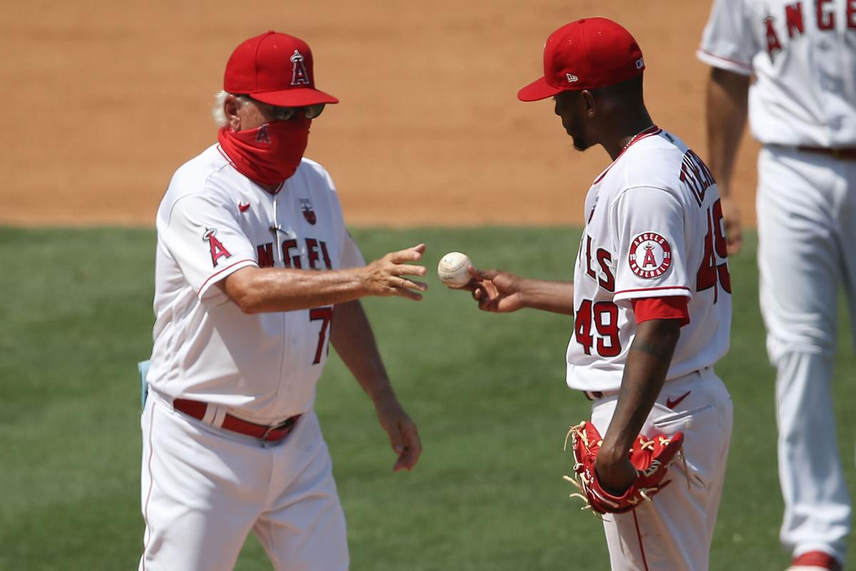 Manager Joe Maddon relieves Julio Teheran #49 of the Los Angeles Angels during the fourth inning of a game against the Los Angeles Dodgers at Angel Stadium of Anaheim on Aug. 16, 2020 in Anaheim, California.