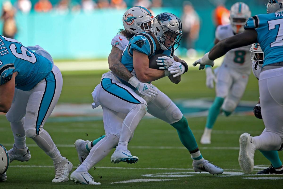 Miami Dolphins linebacker Duke Riley tackles Carolina Panthers running back Christian McCaffrey during the first half at Hard Rock Stadium on Sunday, Nov. 28, 2021 in Miami Gardens, Florida.