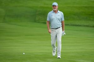 Jerry Kelly walks across the 18th green during the first round of the U.S. Senior Open at Scioto Country Club in Columbus on
