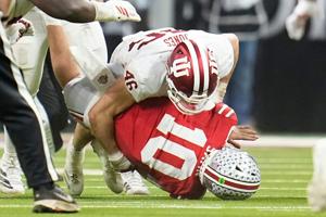 Indiana Hoosiers linebacker Isaiah Jones (46) hits Ohio State Buckeyes quarterback Julian Sayin (10) during the first half of the Big Ten Conference championship game at Lucas Oil Stadium in Indianapolis on Dec. 6, 2025.