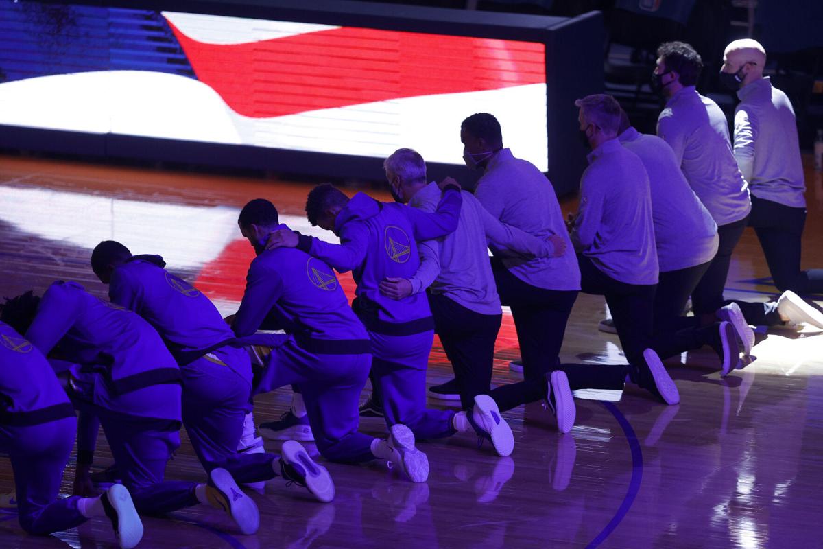 The Golden State Warriors kneel for the national anthem before a game against the Los Angeles Clippers at Chase Center in San Francisco on January 6, 2021.