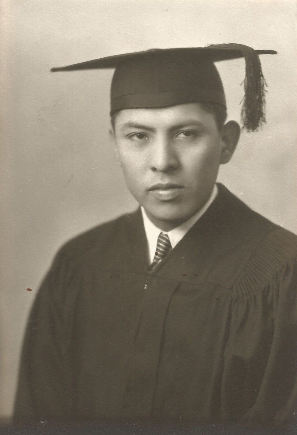 A young Medicine Crow in his graduation gown
