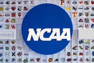 University logos cover a wall in the lobby of NCAA headquarters Thursday, Feb. 25, 2021, in Indianapolis.