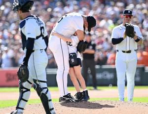 Tigers pitcher Justin Verlander hugs his daughter Genevieve as he is about to exit his final start in the sixth inning.