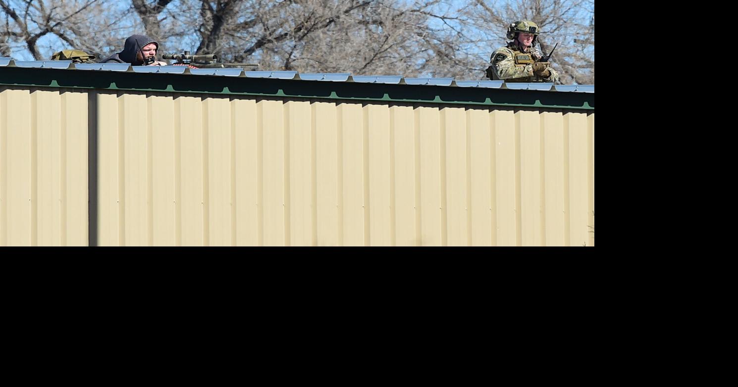 Standoff in the heights continues, officer shot