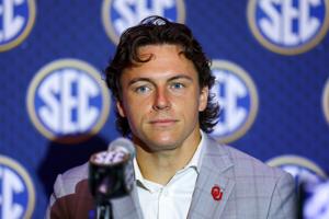 Jul 20, 2026; Tampa, FL, USA; Oklahoma Sooners quarterback John Mateer (10) speaks to the press during SEC Football Kickoff Media Day at the Tampa Marriott. Mandatory Credit: Nathan Ray Seebeck-Imagn Images