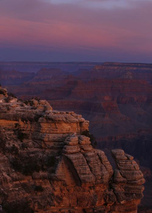 The colors of dawn begin to paint the age-old rock formations of the Grand Canyon along the South Rim near Mather Point on March 11, 2015. Many national parks are so far remaining open during the coronavirus pandemic.