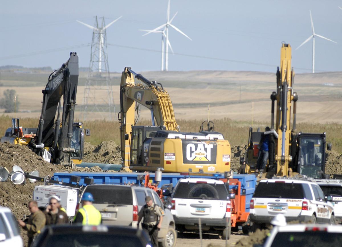 Protesters attached to equipment