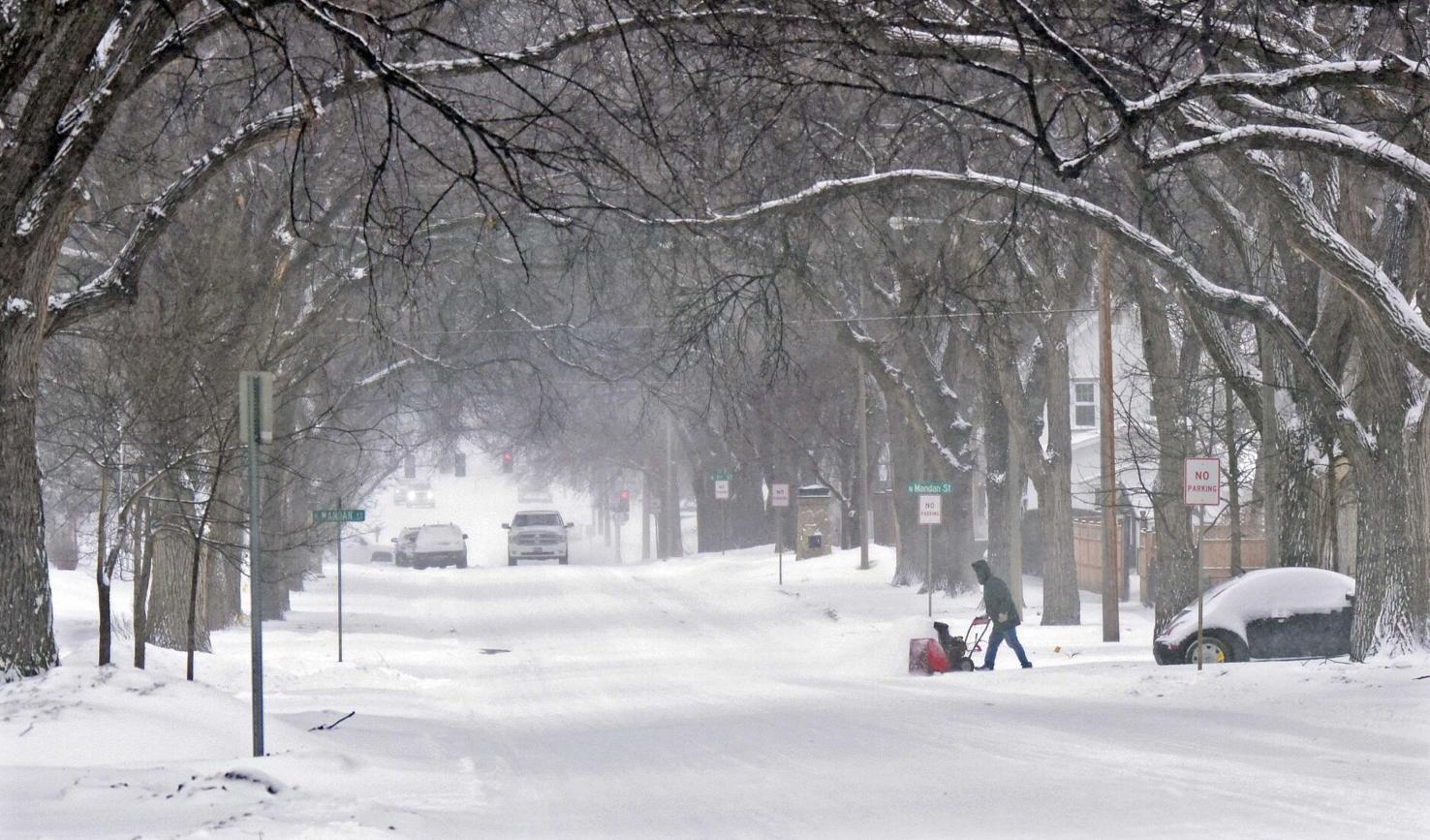 The storm brings snow, wind and cold to North Dakota; multiple chain