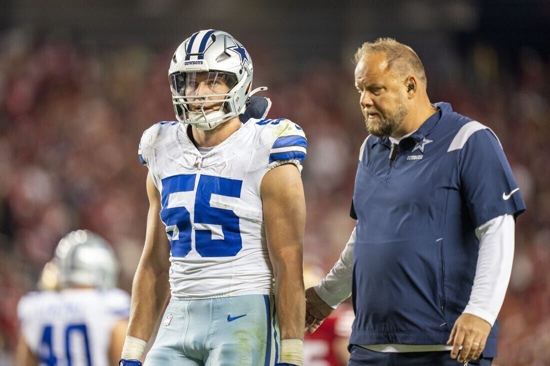 A referee signals Dallas Cowboys football after recovering a