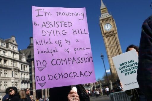 Campaigners in support of assisted dying protest outside the Houses of Parliament in London, as a bill to legalise it fails after running out of time