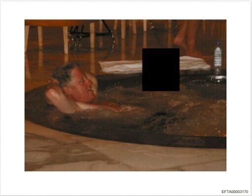 This photo provided by the US Justice Department shows an undated picture of former US president Bill Clinton in a hot tub with an unidentified woman