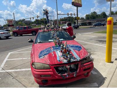 The man behind the red car