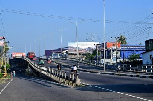 Commuters ride along a deserted street in Colombo on March 25, 2026. Banks have been operating on shorter hours, while many private firms have introduced work-from-home arrangements, according to industry bodies.