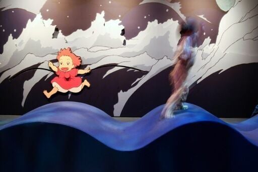 A child plays with an animated character at the Academy Museum of Motion Pictures' exhibit on the Studio Ghibli animated feature 'Ponyo'