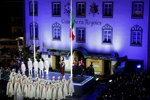 The Italian flag is raised at the Winter Olympics opening ceremony in the centre of the chic ski resort of Cortina d'Ampezzo