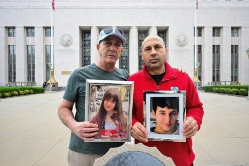 Parents Mariano Janin, and George Nicolaou hold photos of their children outside the Los Angeles County Superior Court in Los Angeles