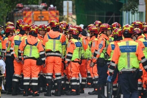 Fire department rescue teams gather after a blaze swept through several apartment blocks at the Wang Fuk Court residential estate in Hong Kong's Tai Po district