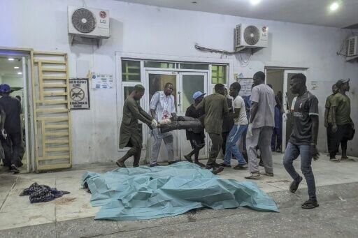 People carry a wounded man through a hospital in Maiduguri
