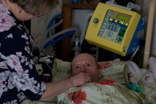 Lying under a crisp, rose-pattern duvet, Kuchynsky can only move his eyes
