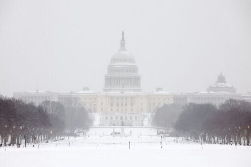 Washington awoke to a blanket of snow expected to cause travel headaches for days
