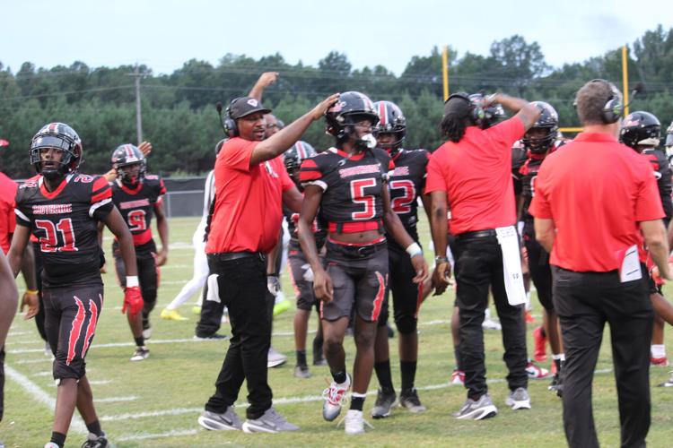 Southside coach patting helmet.JPG