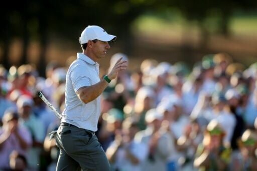 Rory McIlroy celebrates his birdie on the 18th hole to seize a Masters record six-stroke lead after 36 holes