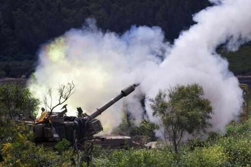 An Israeli self-propelled howitzer artillery gun fires rounds towards southern Lebanon from northern Israel near the border