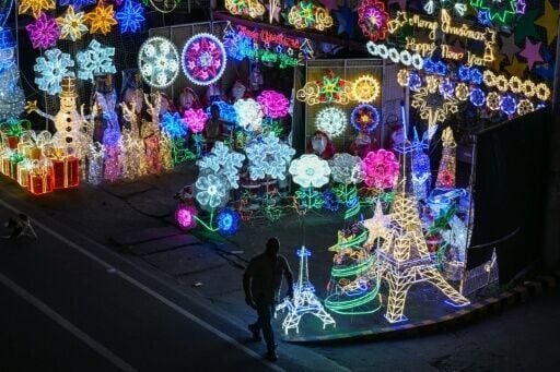 A man walks past a lantern store in San Fernando, in Christmas-mad Philippines