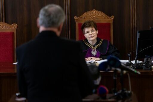 Bishop Andrzej Jez (left) testifies in court in front of Judge Malgorzata Adamczyk