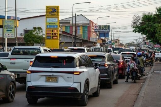 Motorists wait in a queue to refuel their vehicles at a petrol station in Vientiane on March 16, 2026