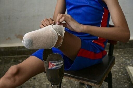Juan Jose Guilarte puts on his bandage at home before heading to his pentathlon training in Havana