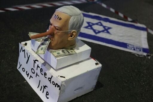 A mask of mocking Israeli Prime Minister Benjamin Netanyahu during a demonstration in Tel Aviv