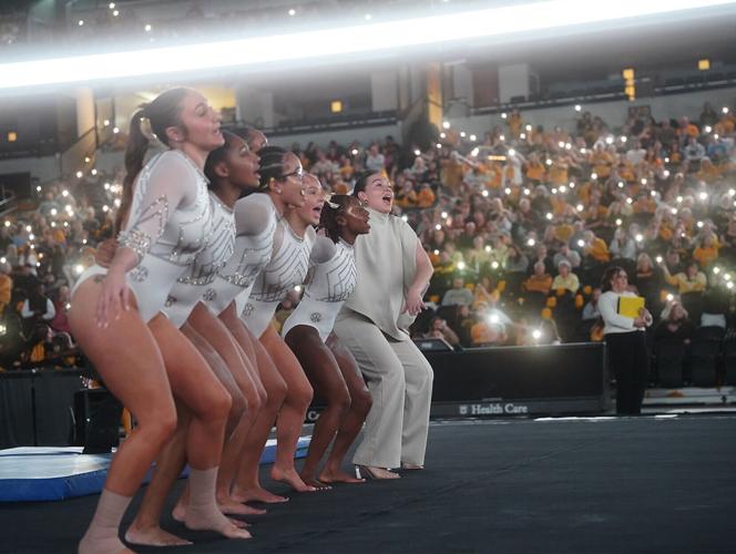 Mizzou gymnasts and one of the coaches link up for the traditional playing