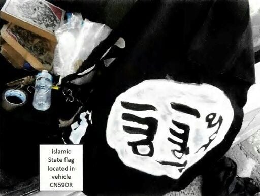 This handout photo from a court exhibit released by the NSW Courts as part of the police facts sheet on December 22, 2025 shows a general view of a home-made painted Islamic State (IS) flag, appearing to be made with white paint on black fabric, located...