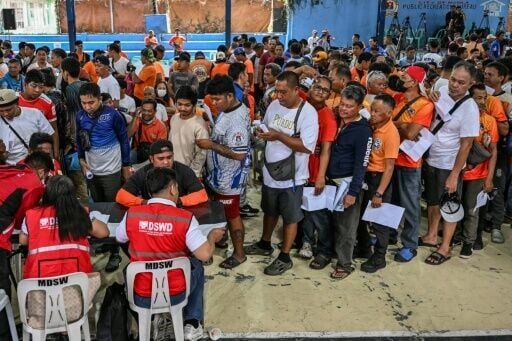 Tricycle drivers queue in Manila on Tuesday for a fuel subsidy meant to offset the soaring cost of petrol