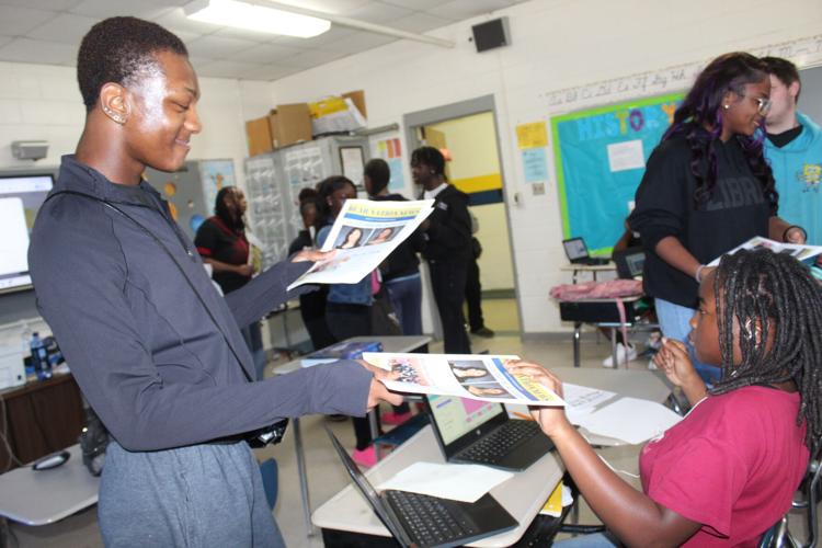 Carlos handing out papers.JPG