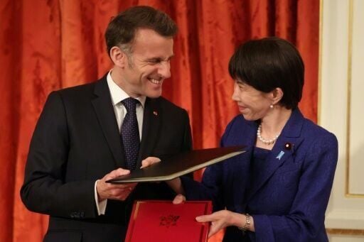 French President Emmanuel Macron (pictured with Japanese Prime Minister Sanae Takaichi) praised Europe's 'predictability' in an apparent swipe at Donald Trump during a visit to Tokyo