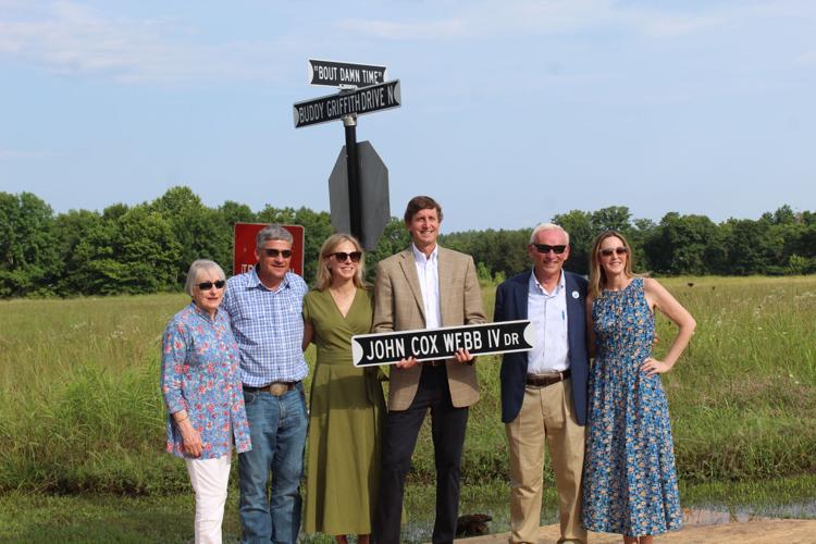Webb family with signs