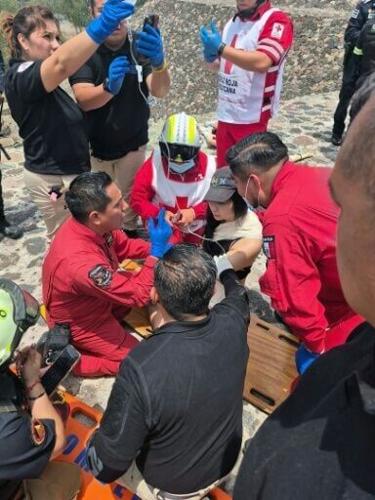 This handout picture released by the Mexican Red Cross shows paramedics assisting a tourist injured at the Pyramid of the Moon in the Teotihuacan