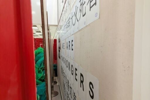 A message on the student union-run notice board, nicknamed “democracy wall”, is seen behind barricades at Hong Kong Baptist University