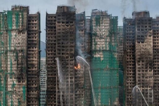 Smoke rises from apartments after a major fire swept through several blocks at the Wang Fuk Court residential estate in Hong Kong's Tai Po district on November 27, 2025