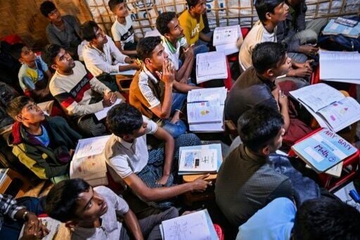 Rohingya refugees study inside a makeshift learning centre at the Kutupalong refugee camp in Ukhia on December 17, 2025