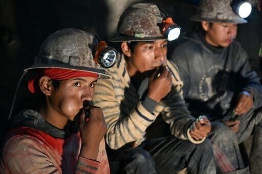 Miners inside Bolivia's Cerro Rico silver mine chew coca leaves for energy