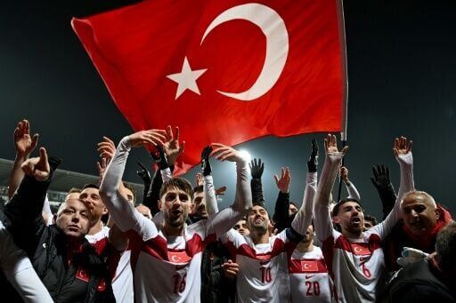Turkey players celebrate after beating Kosovo in Pristina to qualify for the World Cup