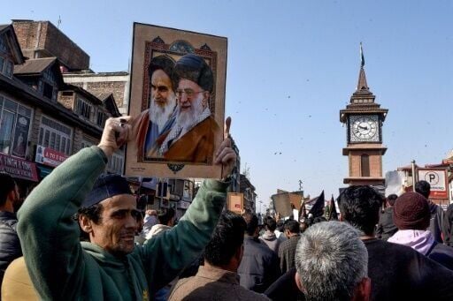 A Shiite Muslim holds a photograph of Iran supreme leader Ayatollah Ali Khamenei (R) and former leader Ayatollah Ruhollah Khomeini during an anti-US and Israel protest in Srinagar on March 1, 2026